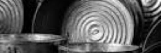 Artistic black and white photo of metal buckets with numbers showcasing industrial design.